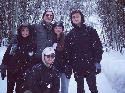 Joe, Jack, Christian, Kate, and William Lando are posing for one big picture as the snow is falling.